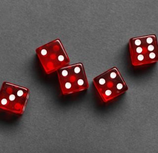Red game dices on grey background